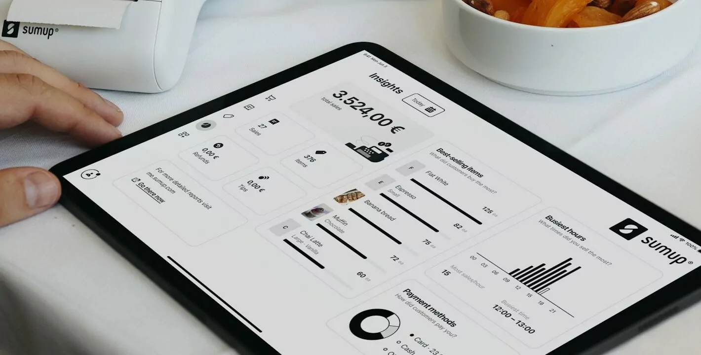 A person sitting at a table with a tablet